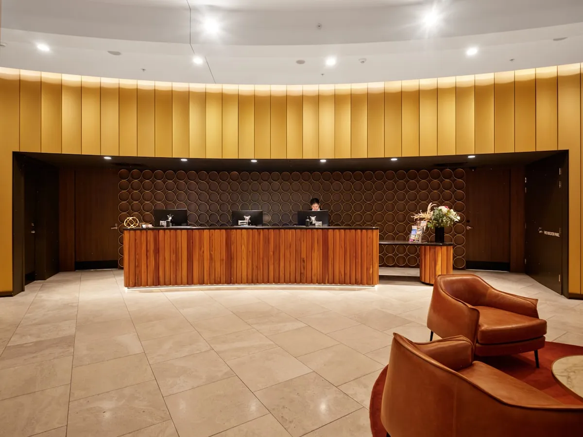 Hotel reception desk with modern wooden furniture and seating